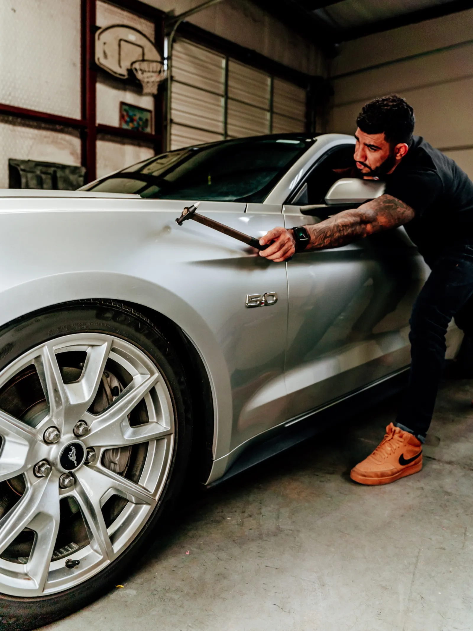 Dent repair on a silver coupe for Andrews TX hail damage service
